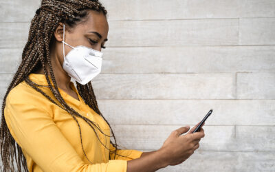 African Woman Wearing Face Medical Mask Using Mobile Smartphone