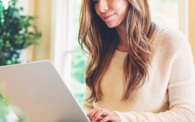 Happy Young Latina Woman Using Her Laptop At Home