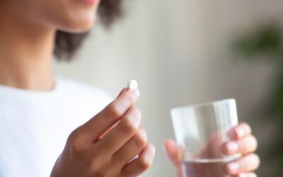 bigstock-Smiling-Woman-Taking-White-Rou-406969337