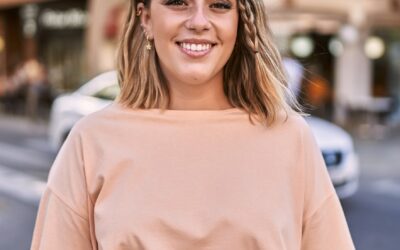 Young hispanic woman smiling confident at street