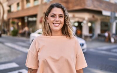 Young hispanic woman smiling confident at street
